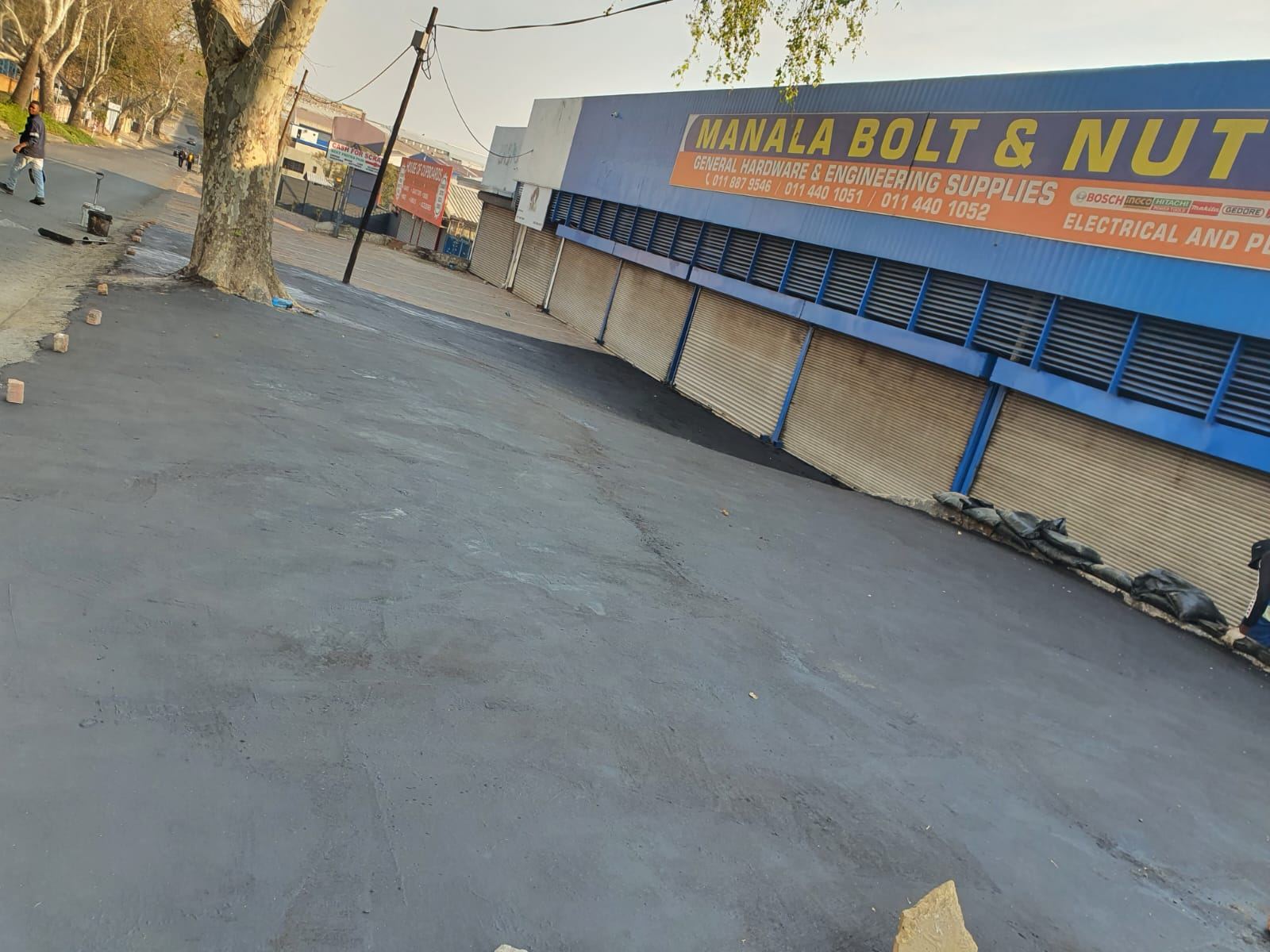 Resurfaced tar area next to shopfront