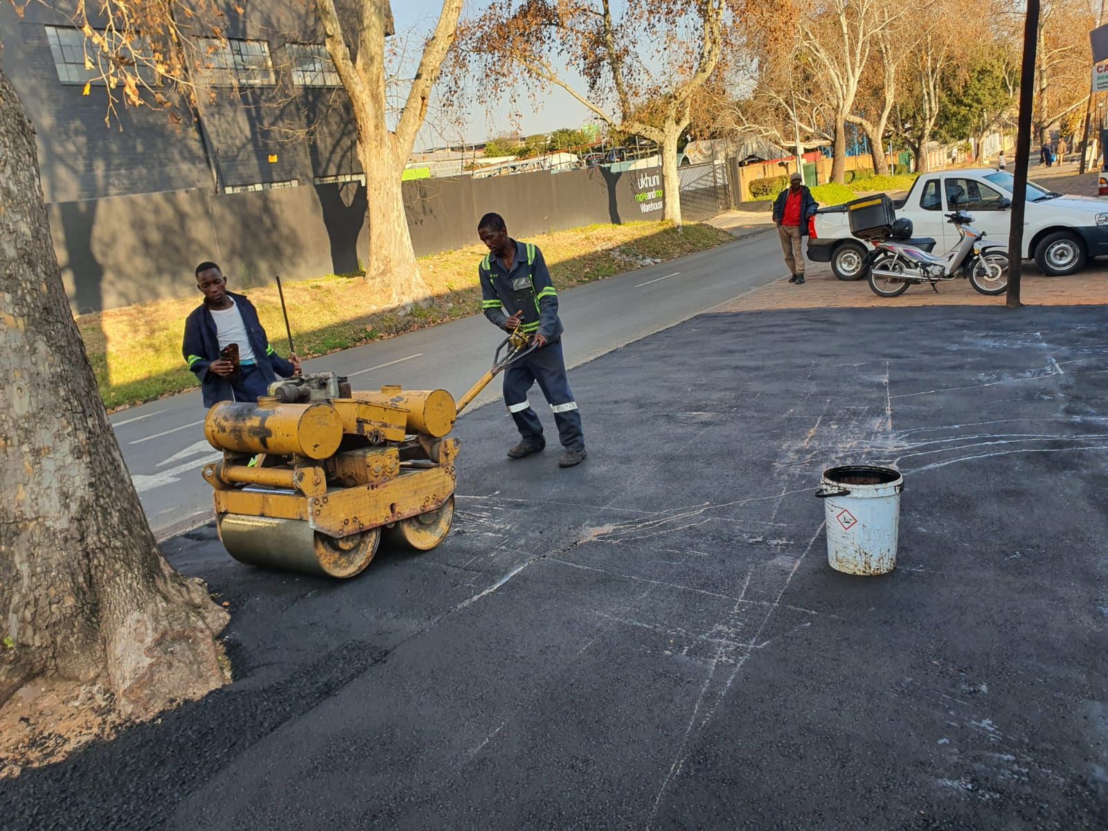 Roller compacting new tar surface