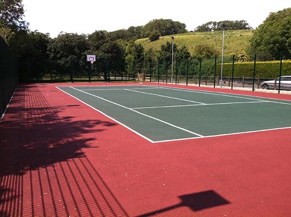 Colour-coated tennis court surface with line marking